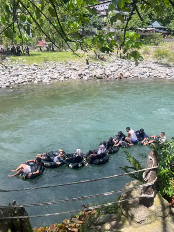 Fun river tubing activity on the river in Bukit Lawang.